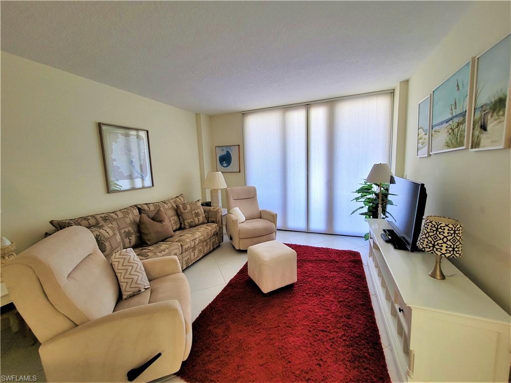 Living room with tile patterned floors and a textured ceiling