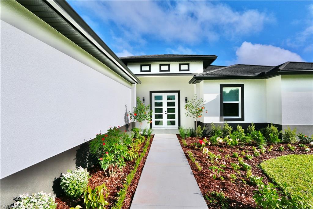 Front Doorway to property with stucco siding and french doors