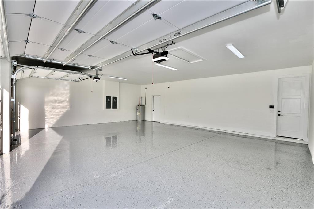 3 car oversized Garage featuring a garage door opener