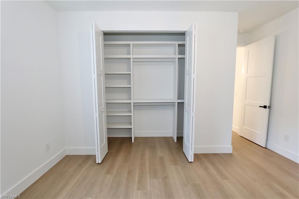 Unfurnished bedroom featuring a closet and light wood-style floors