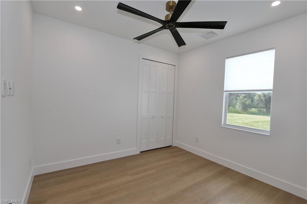Unfurnished bedroom featuring light wood-style floors and a closet