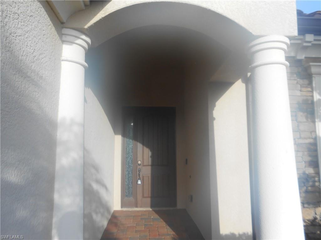 Doorway to property with stucco siding