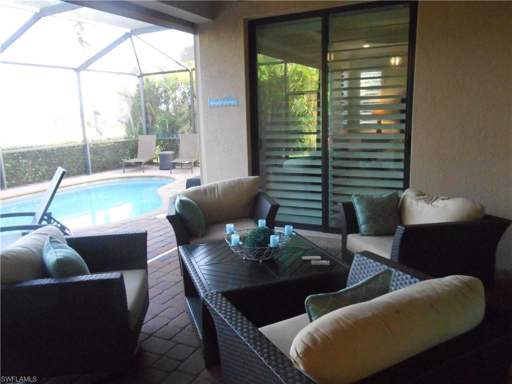 Swimming pool featuring outdoor lounge area, a patio area, a sunroom, and a lanai