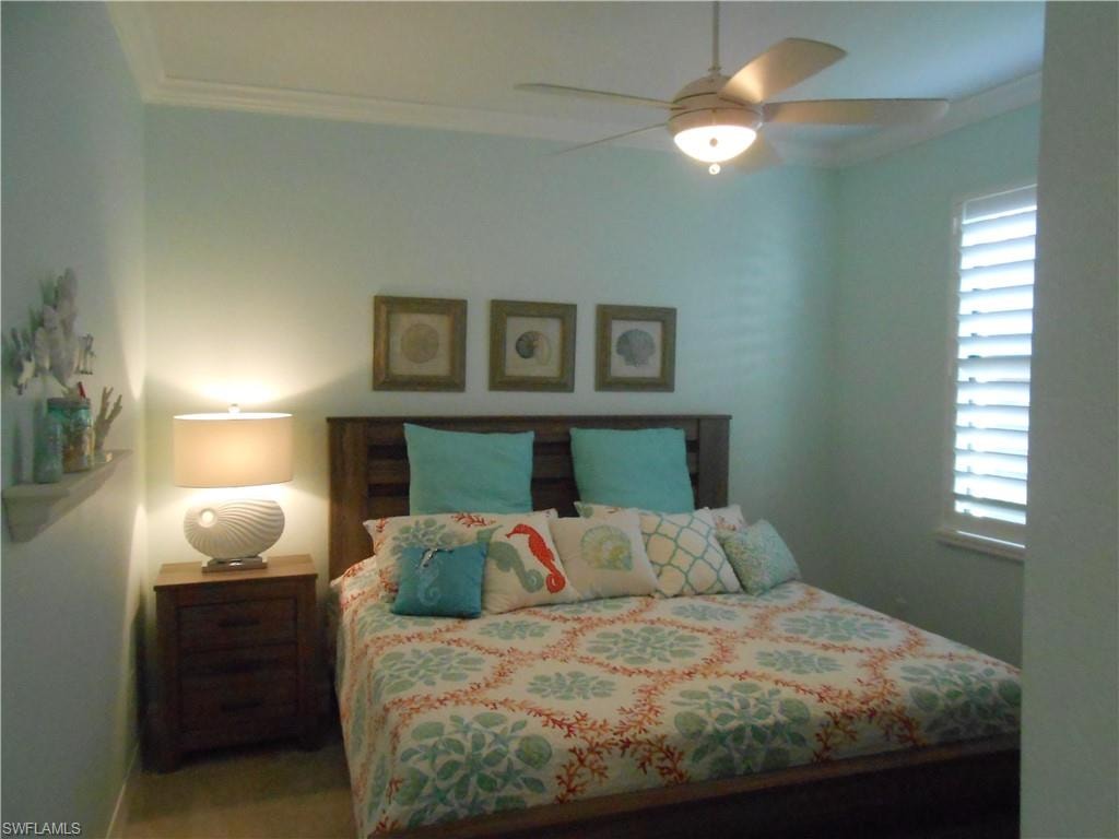 Bedroom featuring ornamental molding and a ceiling fan