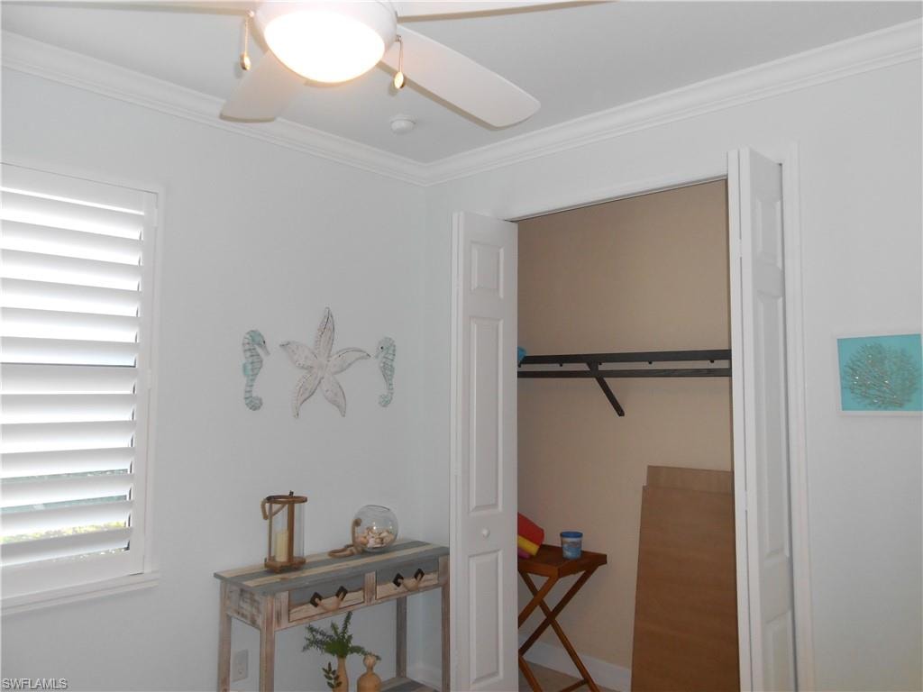 Bedroom featuring ornamental molding and a ceiling fan