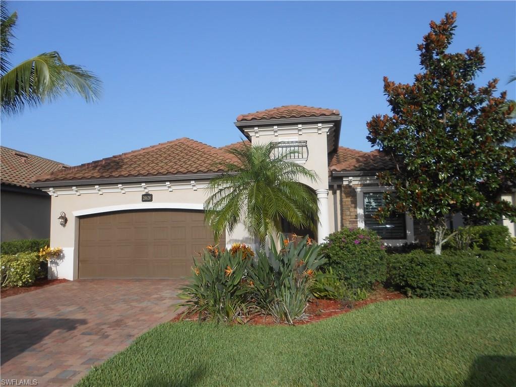 Mediterranean / spanish-style house featuring a garage, stucco siding, decorative driveway, a tile roof, and a front yard