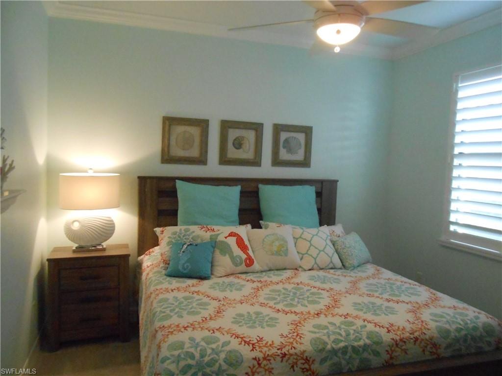 Bedroom with crown molding and ceiling fan