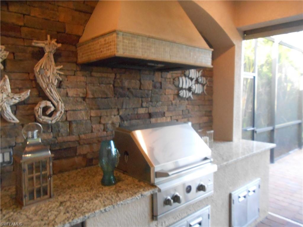 View of patio featuring exterior kitchen