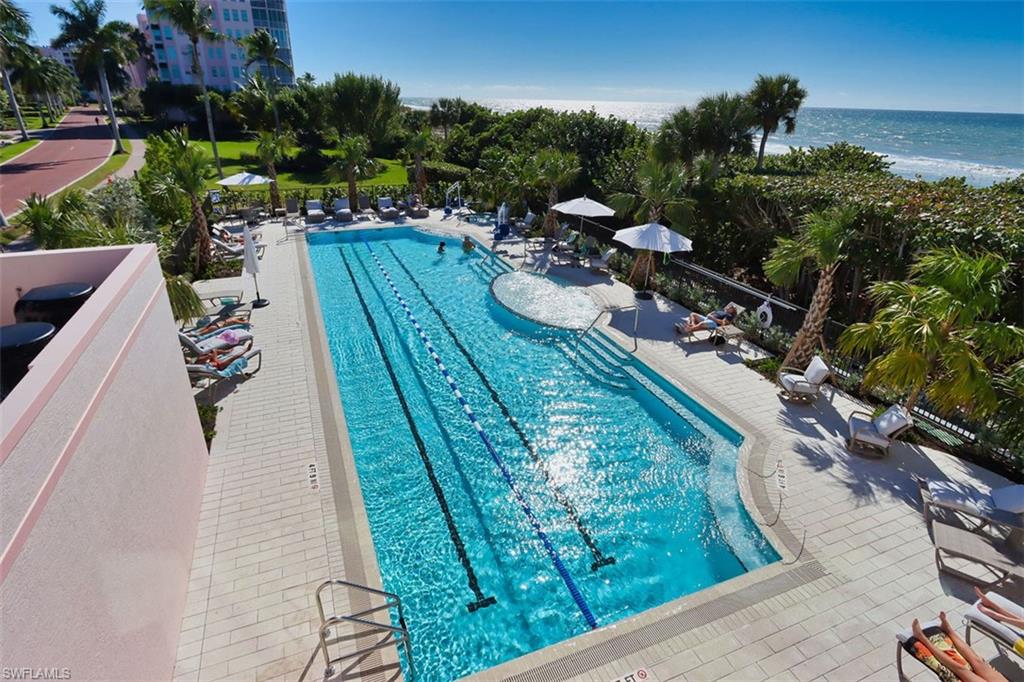 Community pool with a patio and a water view