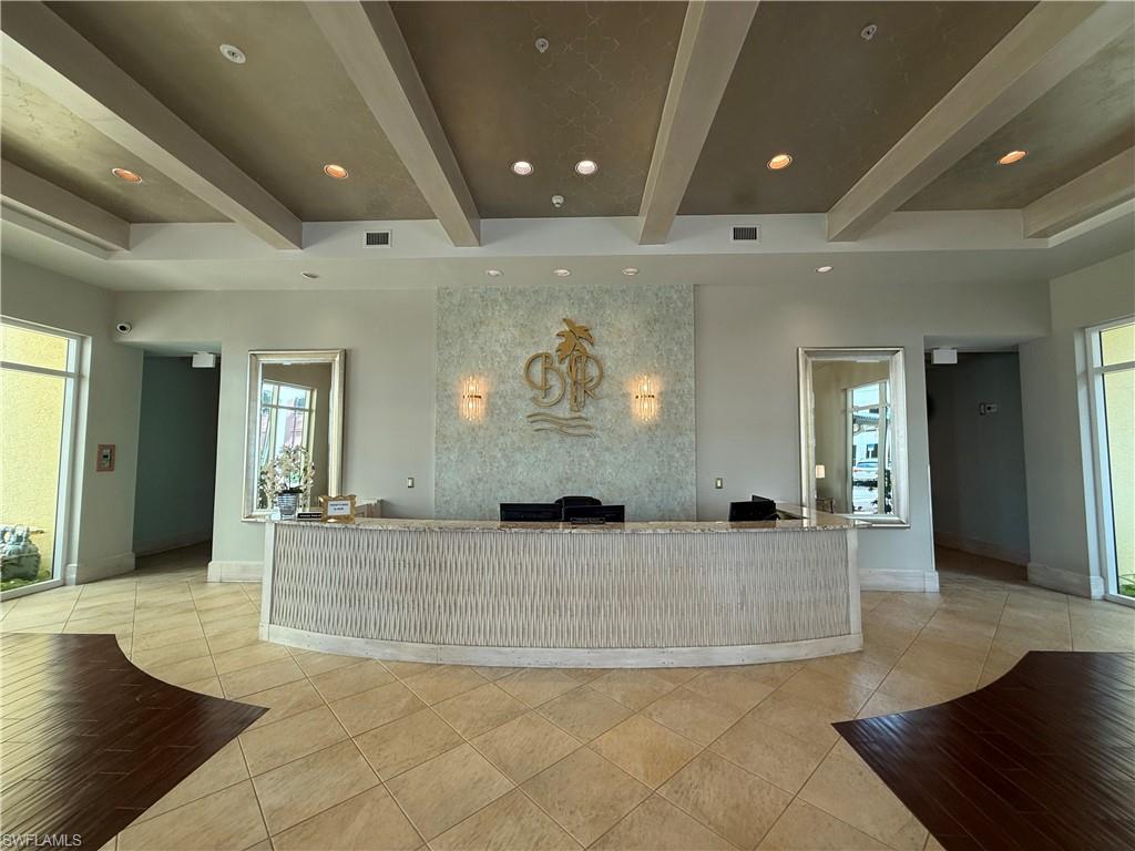 Reception area featuring beam ceiling and recessed lighting