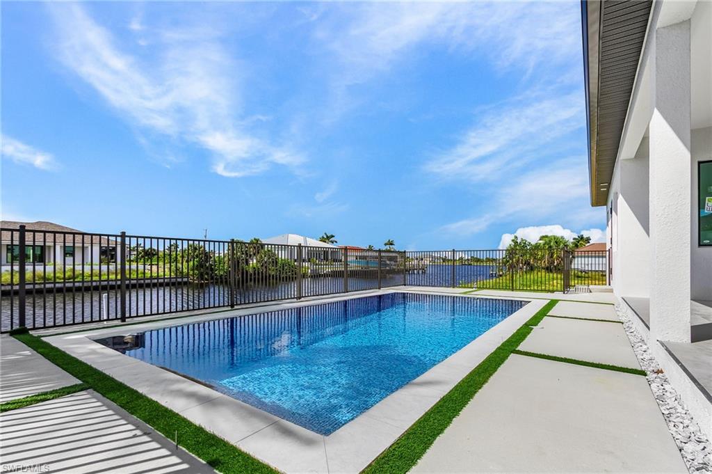 View of pool featuring a water view and a patio area