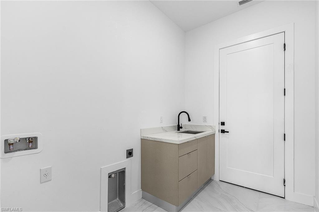 Washroom featuring light marble finish floors, electric dryer hookup, and hookup for a washing machine