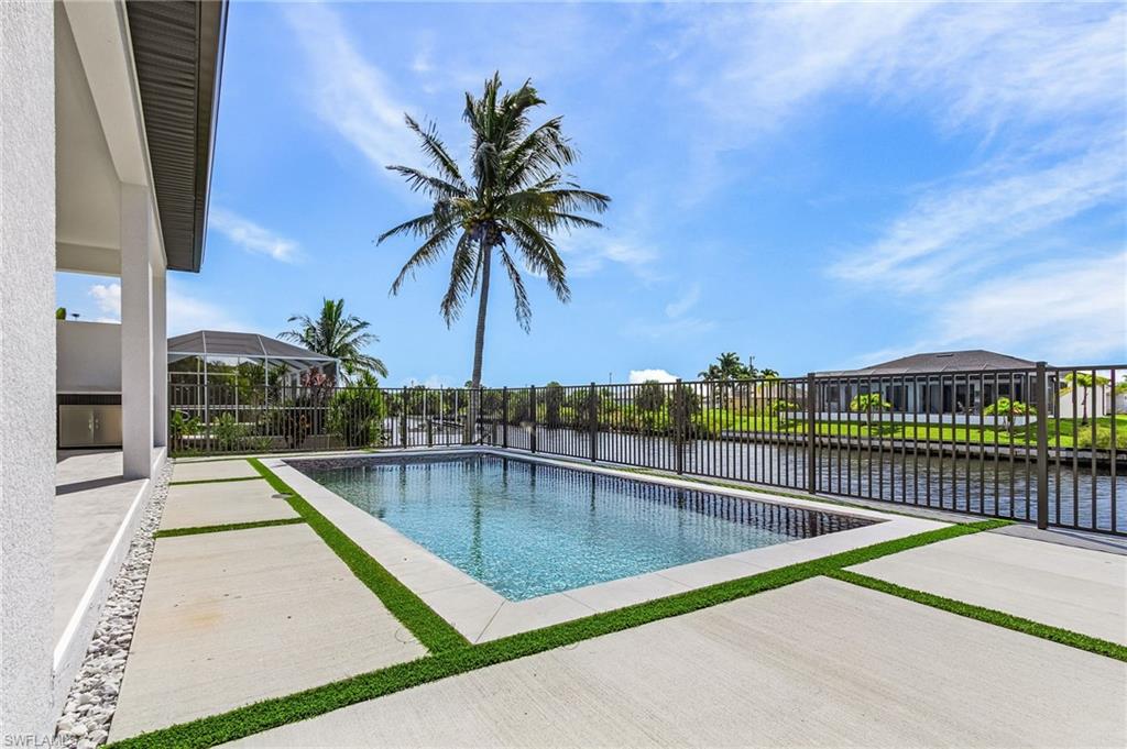 View of pool with a water view and a patio