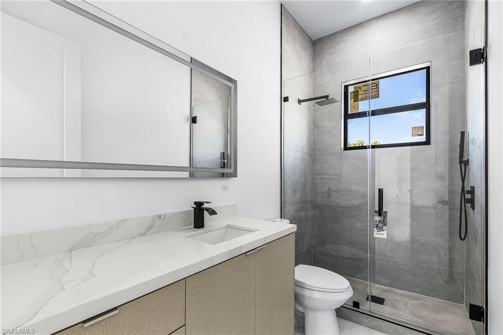 Full bathroom featuring vanity and a shower stall