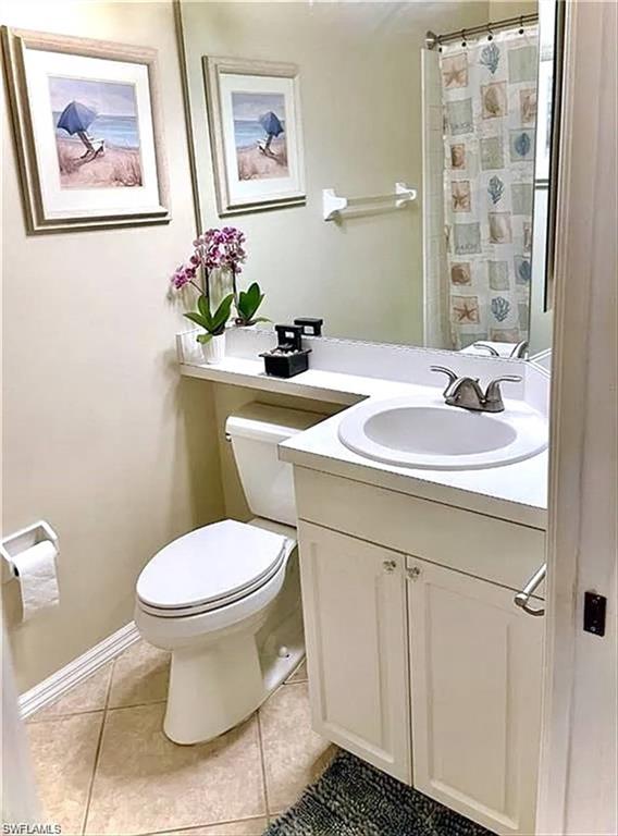 Bathroom featuring a white vanity with a built-in sink, chrome faucet, and panel-front cabinetry
