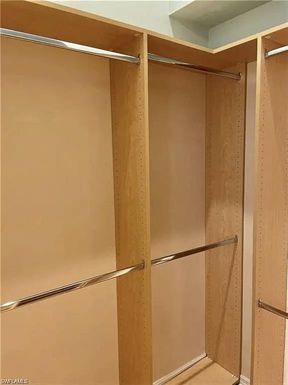 Custom closet system with adjustable shelving and chrome hanging rods