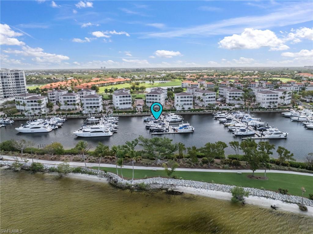 Aerial view of numerous boat docks and a large body of water