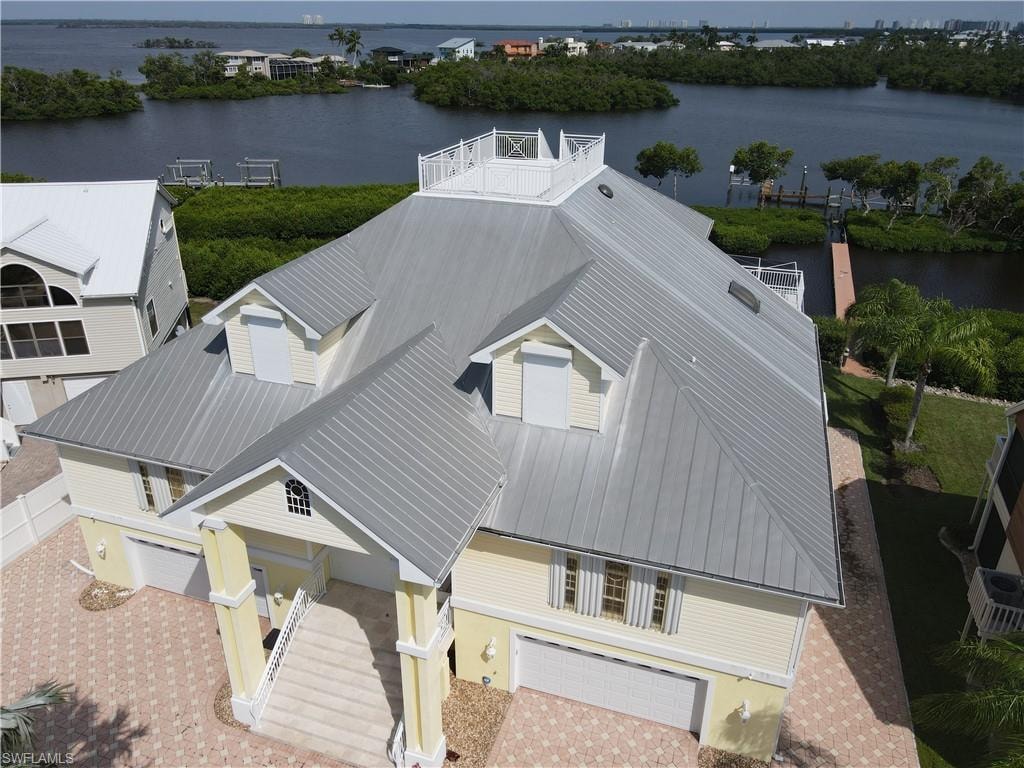 Birds eye view of property with a water view
