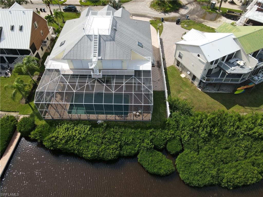 Birds eye view of property with a water view