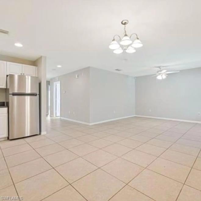 Spare room with light tile patterned floors, a chandelier, a ceiling fan, and recessed lighting