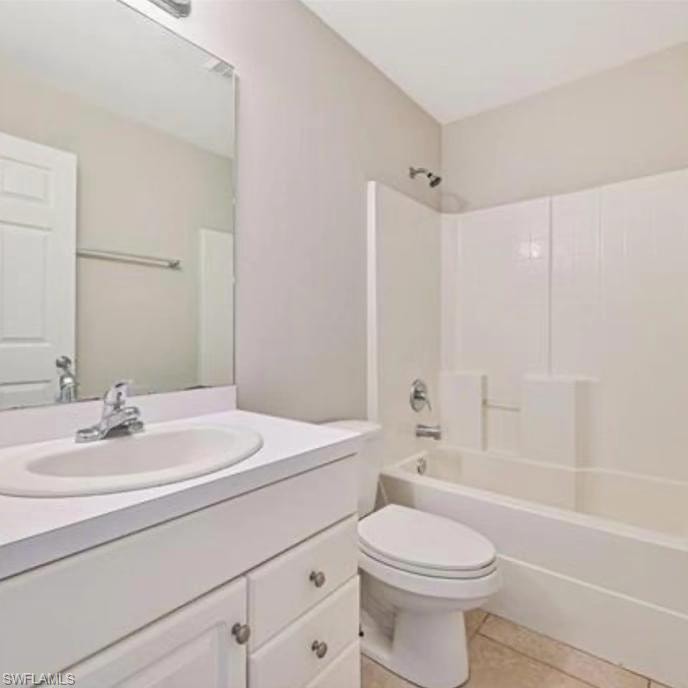 Bathroom featuring bathtub / shower combination, vanity, and light tile patterned flooring