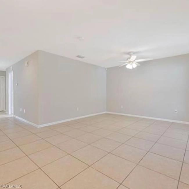 Unfurnished room featuring light tile patterned floors and a ceiling fan