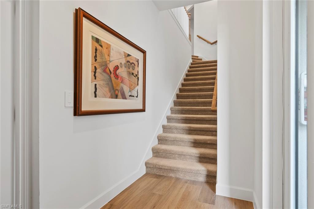 Stairs featuring wood-type flooring