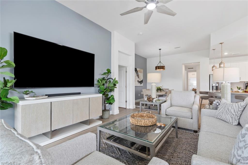 Living room featuring dark hardwood / wood-style flooring and ceiling fan