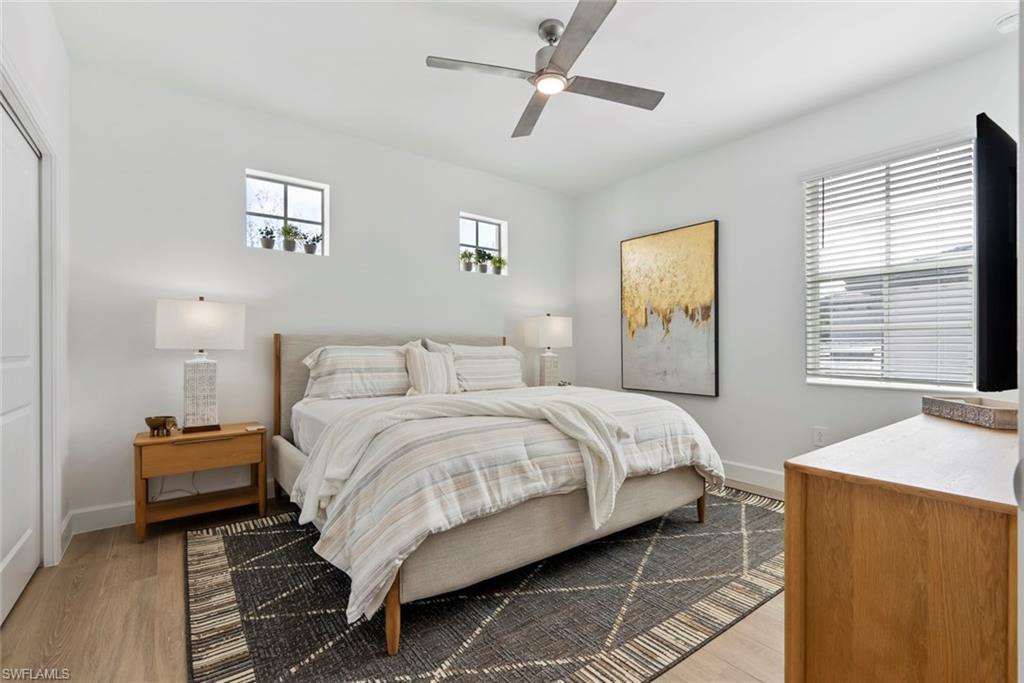 Bedroom with ceiling fan and light hardwood / wood-style flooring
