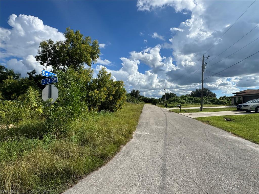 View of asphalt street with traffic signs