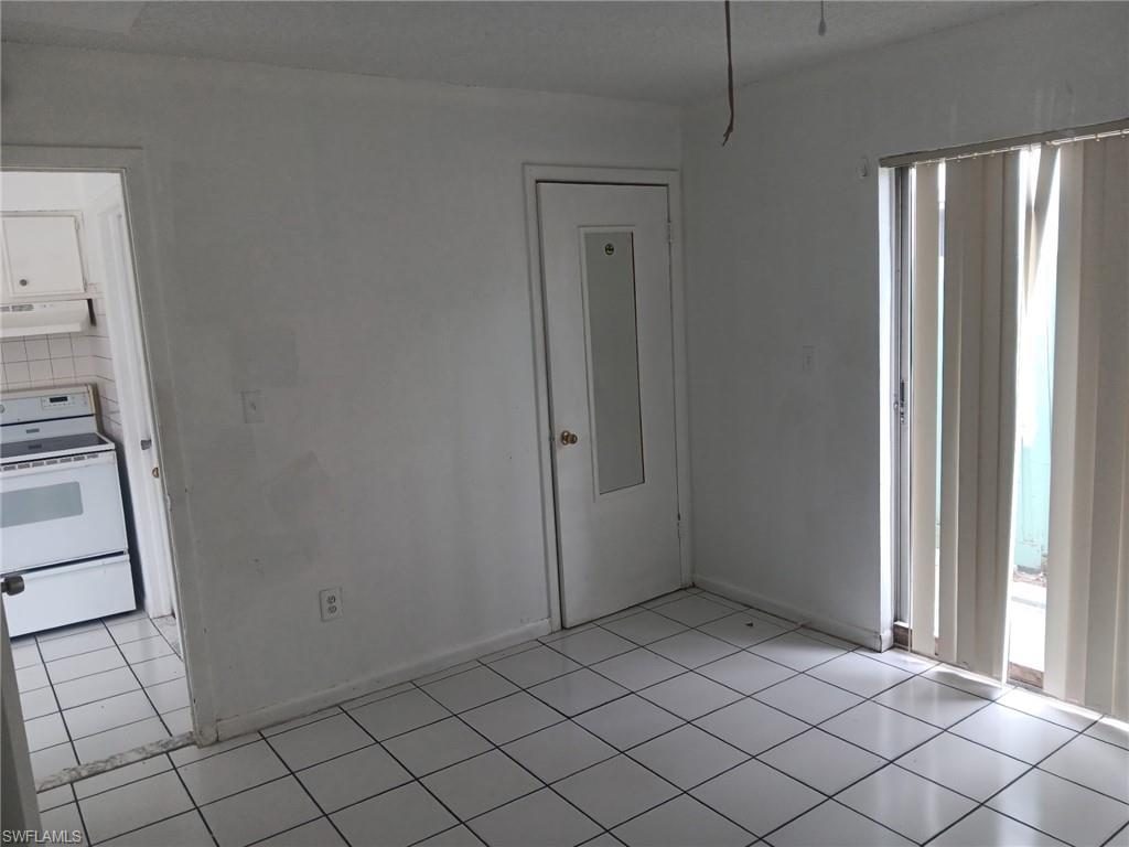 Spare room with light tile patterned floors and baseboards