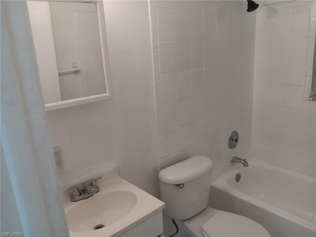 Full bathroom with shower / tub combination and vanity