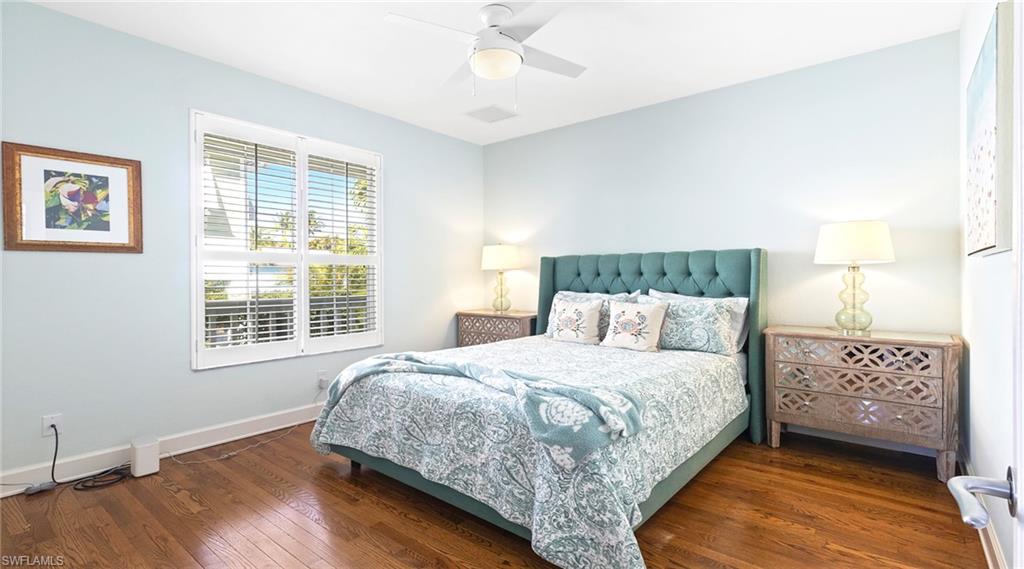 Bedroom with dark wood-style flooring and ceiling fan