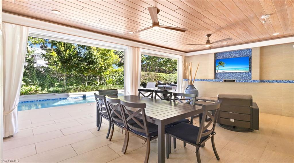 View of patio / terrace with an outdoor pool, a ceiling fan, and outdoor dining space
