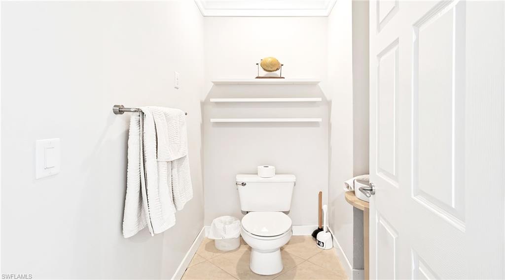Bathroom with toilet and light tile patterned floors