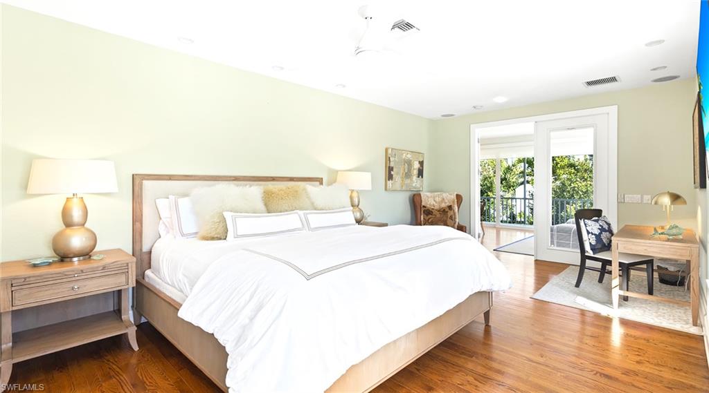 Bedroom with wood finished floors, access to outside, and a ceiling fan
