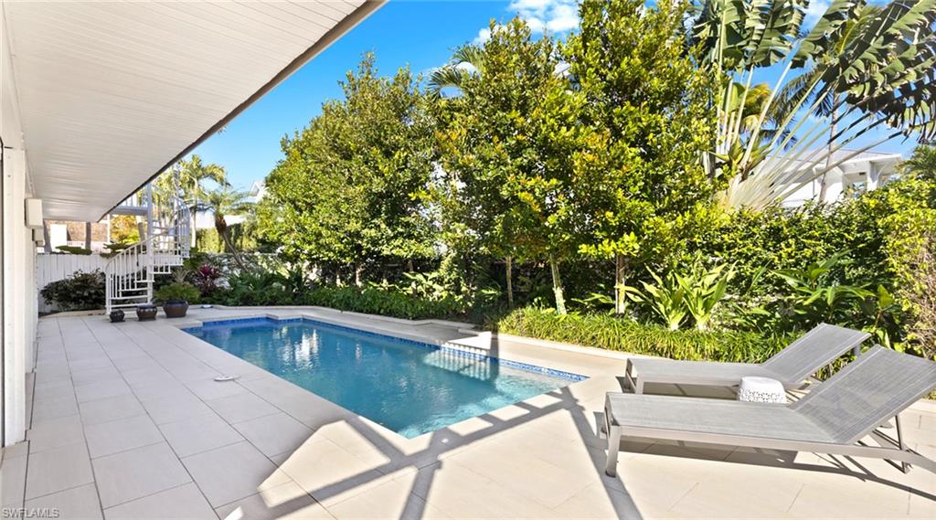Outdoor pool with a patio and a fenced backyard