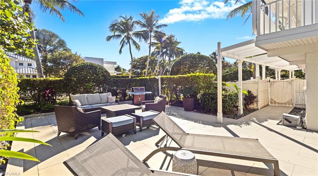 Patio / terrace with an outdoor living space, a patio, a fenced backyard, and a grill