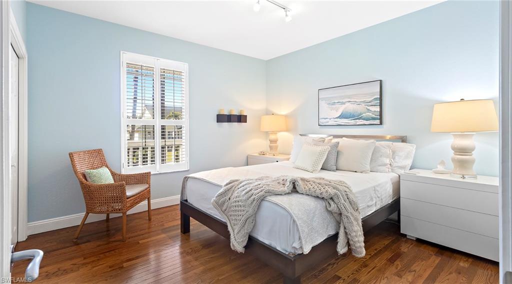 Bedroom featuring dark wood finished floors and rail lighting