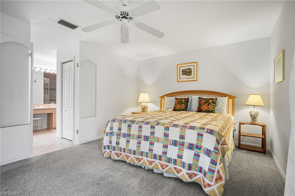 The first-floor primary suite has room for a king bedroom set plus sitting area, and has direct access to the screened lanai.