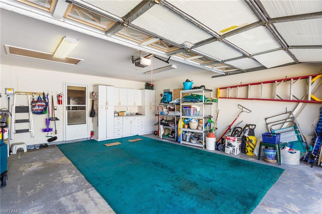 The two-car garage enters into the kitchen, and has plenty of storage space toward the front and on both sides.