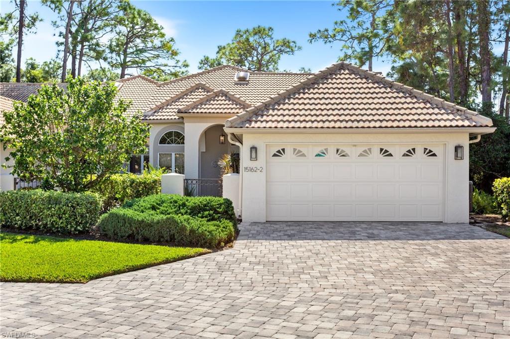 The beautiful exterior features tile roofs, paver drives, and chic fixtures.
