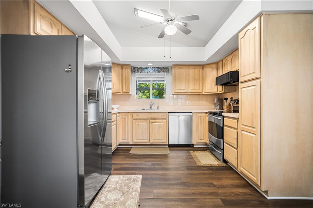 The spacious kitchen has stainless appliances, plenty of cabinet space and a floor-to-soffitpantry. The ceiling vaults up toward the greatroom, allowing more light in and the sense of even more space. The soffits are open above, meaning no load-bearing walls to worry about, if you want to open up the space to the great room.