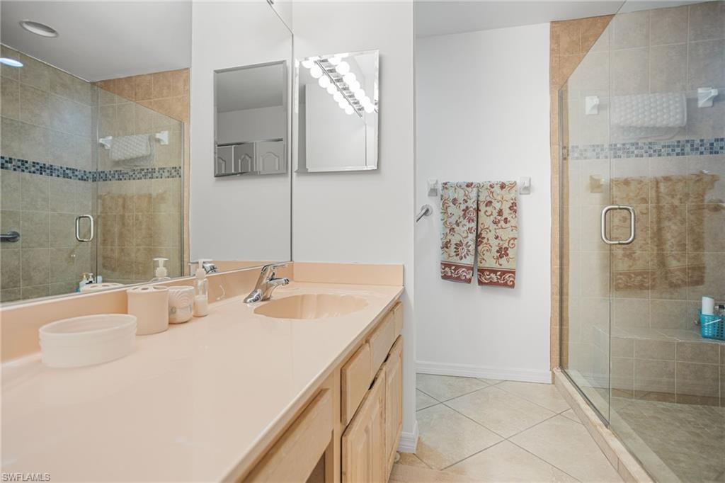 The first-floor primary bathroom has a large, beautifully tiled walk-in shower and extra-wide vanity.