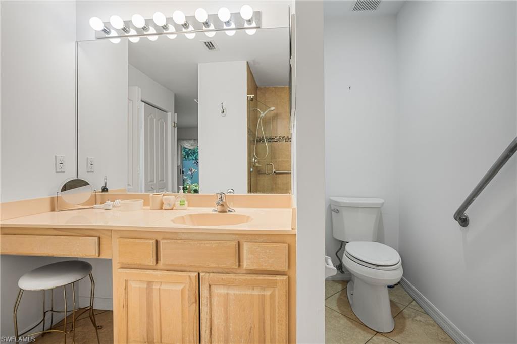 The first-floor primary bathroom has a large, beautifully tiled walk-in shower and extra-wide vanity.