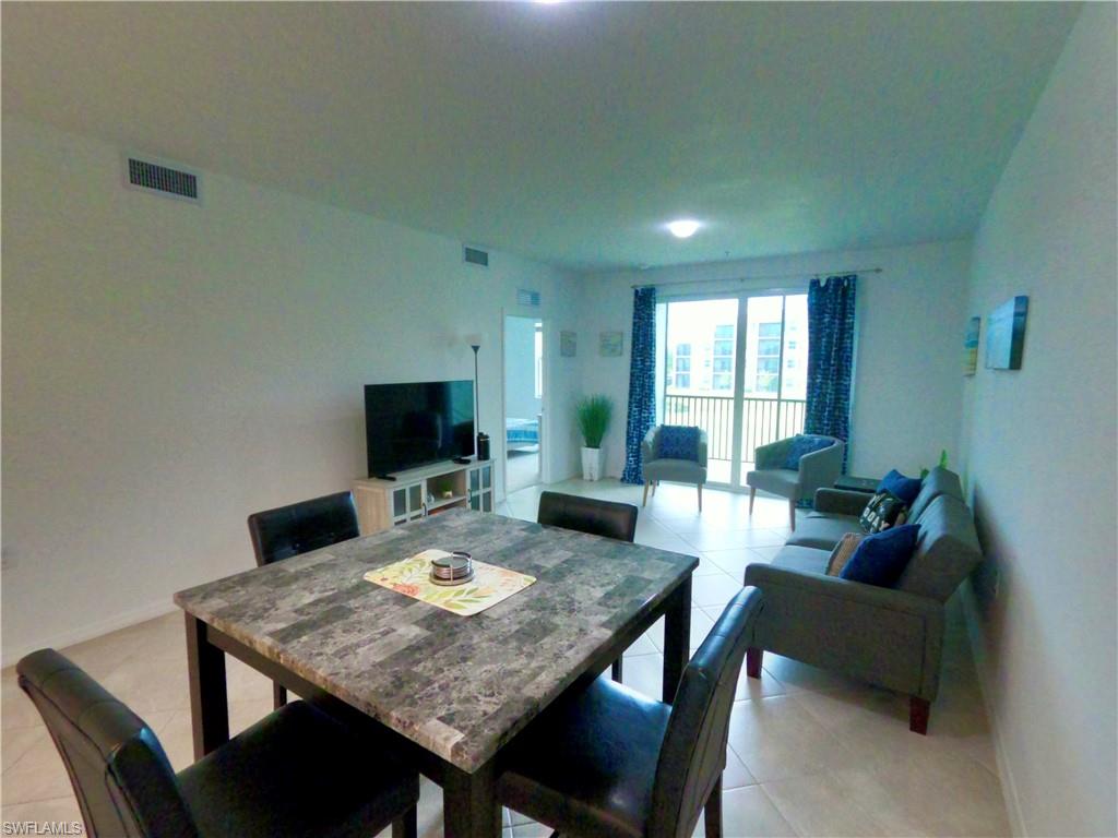 Dining space featuring light tile patterned floors and baseboards