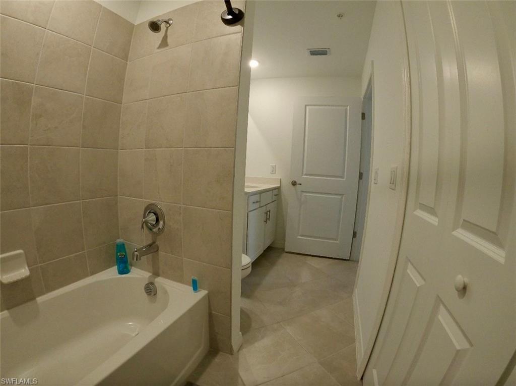 Full bathroom with  shower combination, vanity, and light tile patterned flooring
