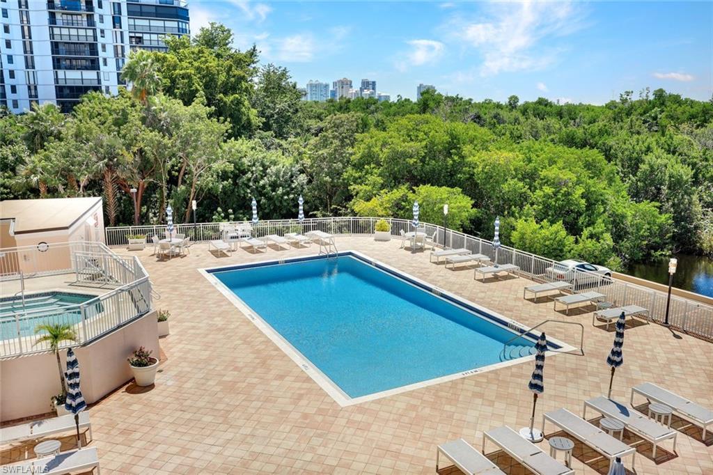 Community pool with a patio area and a view of skyline