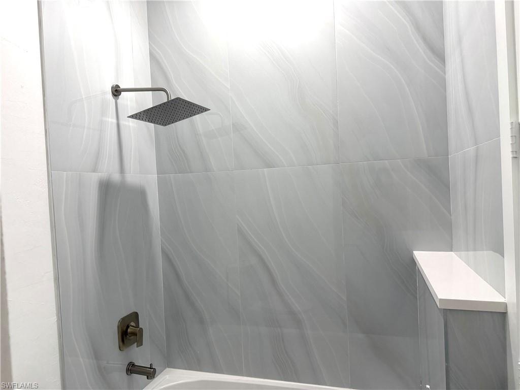 Hallway featuring light marble finish floors and recessed lighting