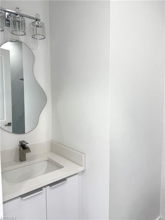 Kitchen featuring modern cabinets, light marble finish floors, healthy amount of natural light, and dishwashing machine